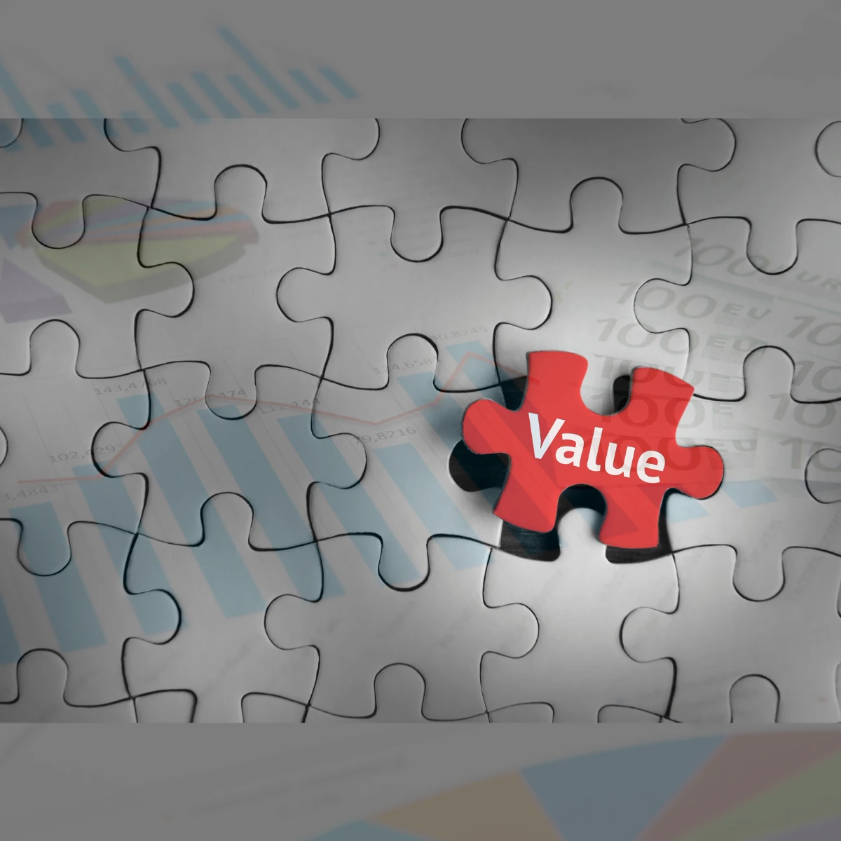 A value puzzle piece assembling with the rest of the pieces. The puzzle representing a company's financial data and a stock market chart